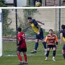 Harworth Colliery captain Billy Ball heads clear against Kiveton Miners Welfare. Picture: John Mushet