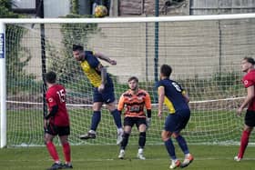 Harworth Colliery captain Billy Ball heads clear against Kiveton Miners Welfare. Picture: John Mushet