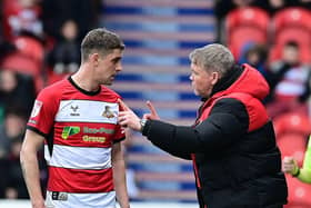 Harrison Biggins receives instructions from manager Grant McCann.