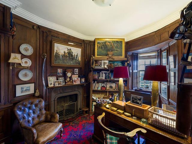 The cosy study has a fire place and views out over the garden.