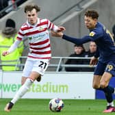 Doncaster's Kyle Hurst dribbles past Wimbledon's Kasey McAteer.