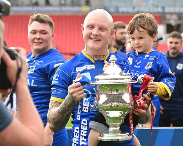 Dons' Tom Halliday celebrates promotion.