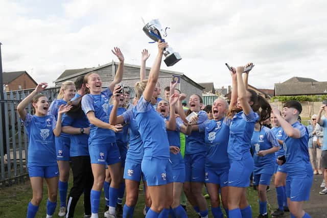Rossignton Main captain Steph Prescott holds aloft the trophy. Picture: Julian Barker