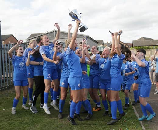 Rossignton Main captain Steph Prescott holds aloft the trophy. Picture: Julian Barker