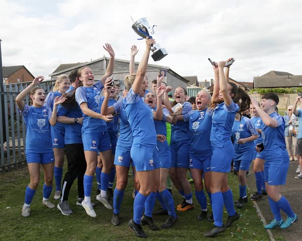 Rossignton Main captain Steph Prescott holds aloft the trophy. Picture: Julian Barker