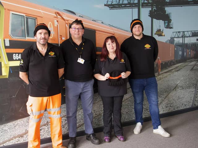 Freightliner Train Service Controller Karen Gyte (second right) is pictured with colleagues in their knitted hats.