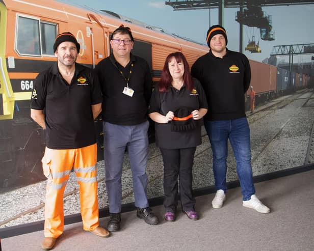 Freightliner Train Service Controller Karen Gyte (second right) is pictured with colleagues in their knitted hats.