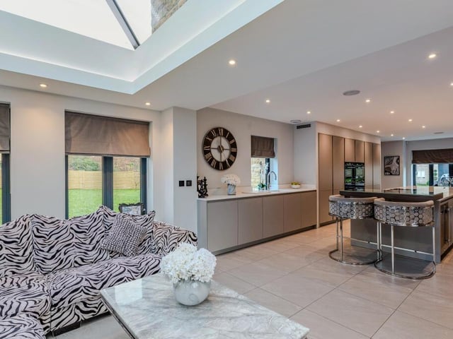 The stunning, high spec living kitchen has bi-fold doors to the gardens.