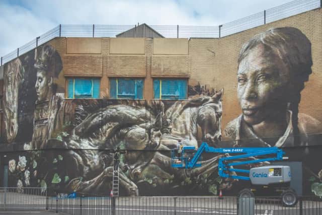The mural includes horses to represent Doncaster's long history with horse racing. 
Photo by: Street Art Atlas