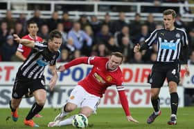Wayne Rooney of Manchester United in action with Mike Williamson of Newcastle United during the Barclays Premier League match between Newcastle United and Manchester United at St James' Park on March 4, 2015 in Newcastle upon Tyne, England.  (Photo by Matthew Peters/Manchester United via Getty Images)