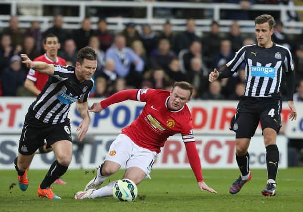 Wayne Rooney of Manchester United in action with Mike Williamson of Newcastle United during the Barclays Premier League match between Newcastle United and Manchester United at St James' Park on March 4, 2015 in Newcastle upon Tyne, England.  (Photo by Matthew Peters/Manchester United via Getty Images)