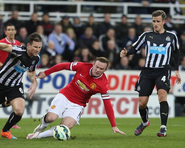 Wayne Rooney of Manchester United in action with Mike Williamson of Newcastle United during the Barclays Premier League match between Newcastle United and Manchester United at St James' Park on March 4, 2015 in Newcastle upon Tyne, England.  (Photo by Matthew Peters/Manchester United via Getty Images)