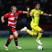 Gareth Roberts battles Geovani Dos Santos of Tottenham Hotspur during a Carling Cup clash at the Keepmoat Stadium in 2009 (photo by Alex Livesey/Getty Images).
