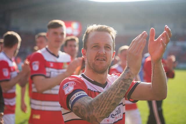 Doncaster Rovers captain James Coppinger celebrates promotion back to League One in 2017