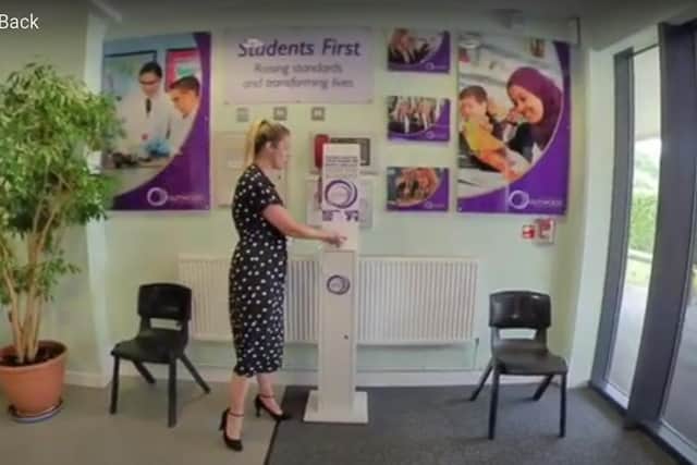 Outwood Academy Adwick assistant principal Hannah Smith shows a hand sanitiser at the door