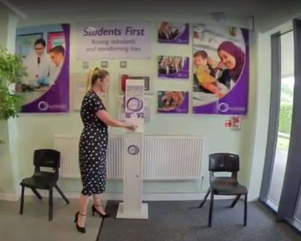 Outwood Academy Adwick assistant principal Hannah Smith shows a hand sanitiser at the door