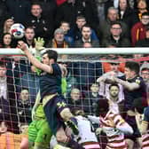 Doncaster's keeper Johnny Mitchell is seemingly impeded by Sam Stubbs for the goal.