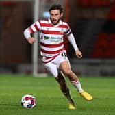 Doncaster Rovers winger Jon Taylor runs with the ball against Barnsley.