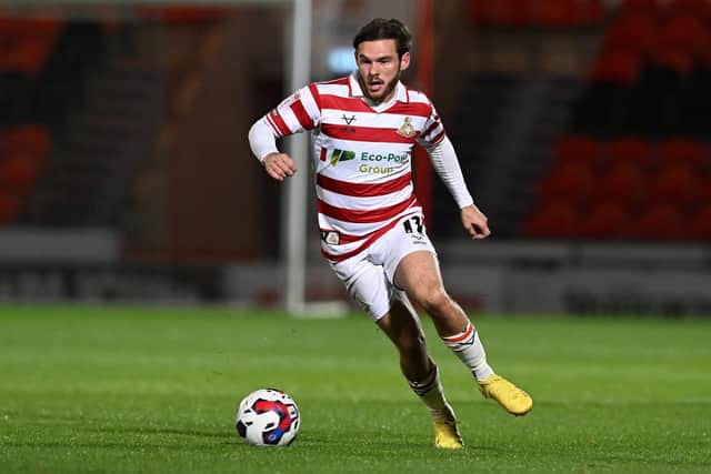 Doncaster Rovers winger Jon Taylor runs with the ball against Barnsley.