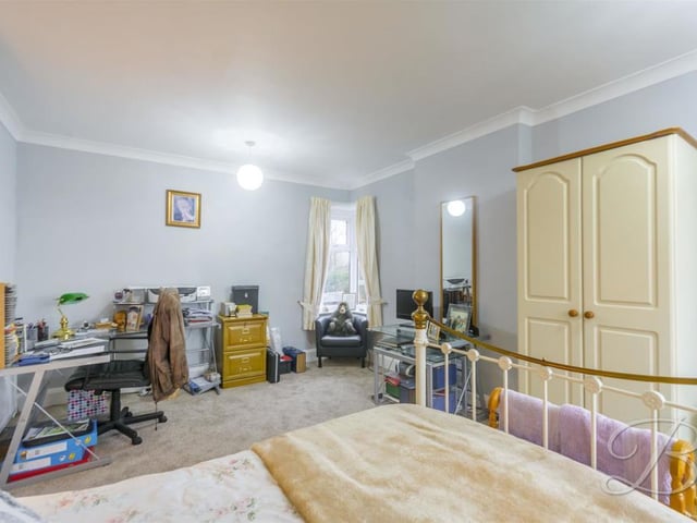 A second shot of the second bedroom, showing there is an abundance of space. Room for desk, wardrobe, chair and storage cupboards.