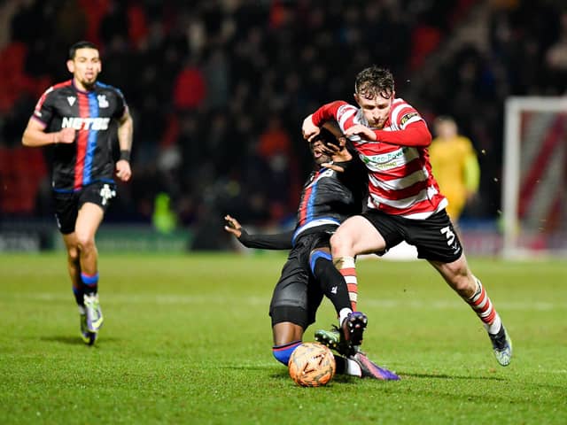 Doncaster Rovers' James Maxwell rides a tackle for Crystal Palace player
Picture Connor McMain/AHPIX LTD; Football; FA Cup Round 4;
Doncaster Rovers v Crystal Palace ;
10/02/2025 7:45pm; The Eco-Power Stadium;