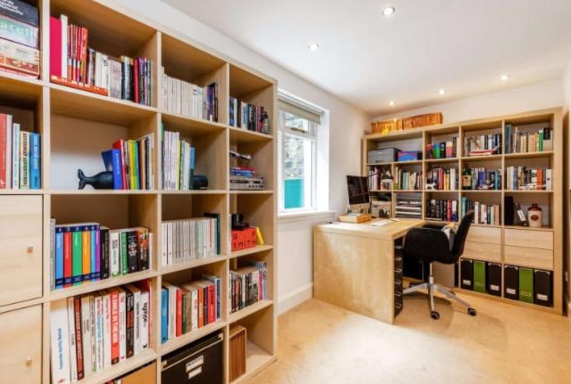 The third bedroom in the house is currently being used as a roomy home office