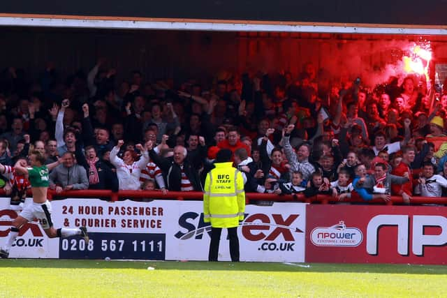 James Coppinger celebrates scoring in front of the Rovers fans at Brentford