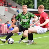 Ollie Younger takes on an FC United of Manchester player during pre-season.