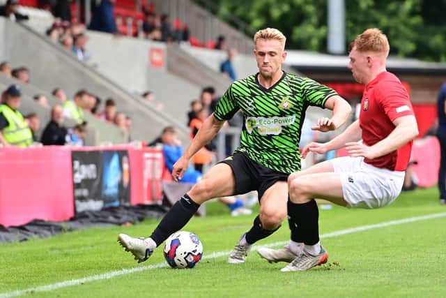 Ollie Younger takes on an FC United of Manchester player during pre-season.