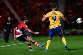 Tom Nixon puts the cross in for Doncaster Rovers.