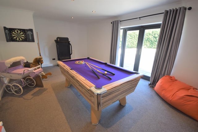 The play room benefits from opening doors which lead out onto the patio and hot tub.