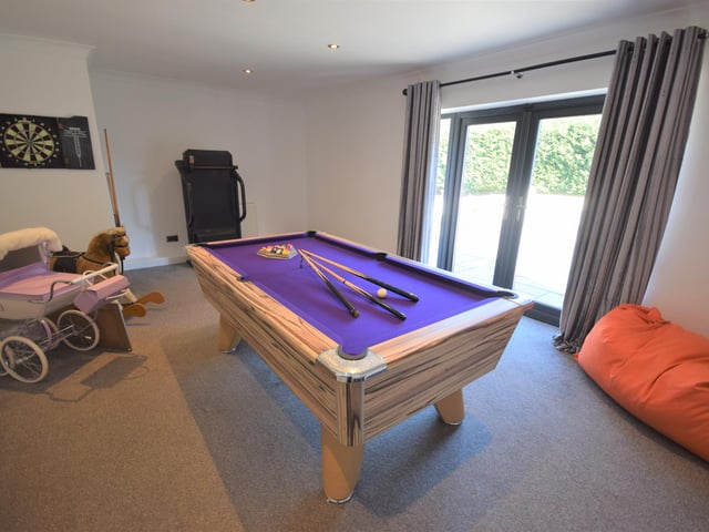 The play room benefits from opening doors which lead out onto the patio and hot tub.
