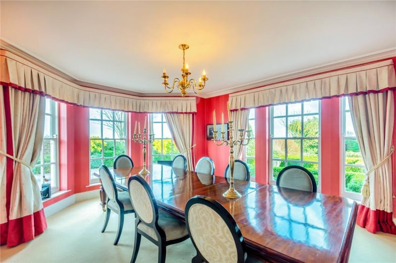 The dining room is flooded in light, thanks to its many windows.