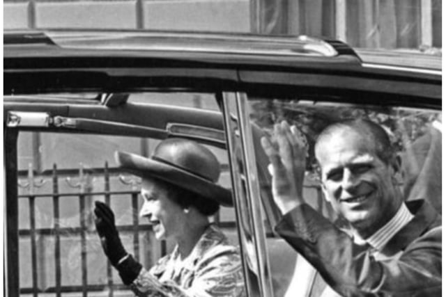 The Queen and Prince Philip wave to crowds outside the Mansion House.