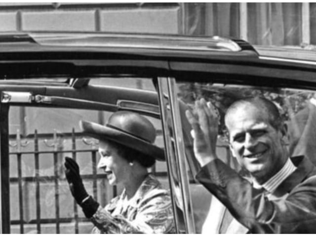 The Queen and Prince Philip wave to crowds outside the Mansion House.