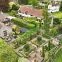 An overview of the impressive property, with imaginative landscaped gardens.
