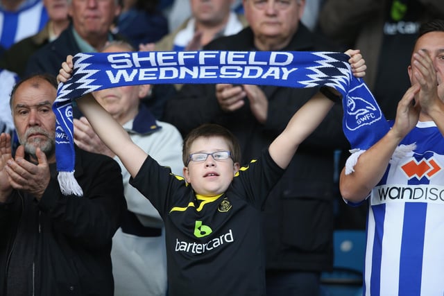 A Wednesday fan gets behind his team during the Sky Bet Championship match with Nottingham Forest at Hillsborough in August 2014.