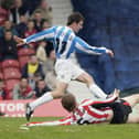 Danny Schofield skips the tackle of Brentford defender Michael Turner at Griffin Park in 2005 (photo by Ker Robertson/Getty Images).