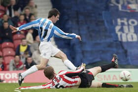 Danny Schofield skips the tackle of Brentford defender Michael Turner at Griffin Park in 2005 (photo by Ker Robertson/Getty Images).
