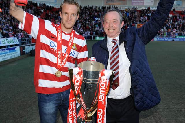 Brian Flynn, with James Coppinger, after winning the League One title
