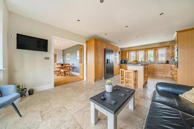 A view of the kitchen and dining room from this relaxed open plan seating area.