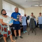 Bev and volunteers with some of the donated school uniforms