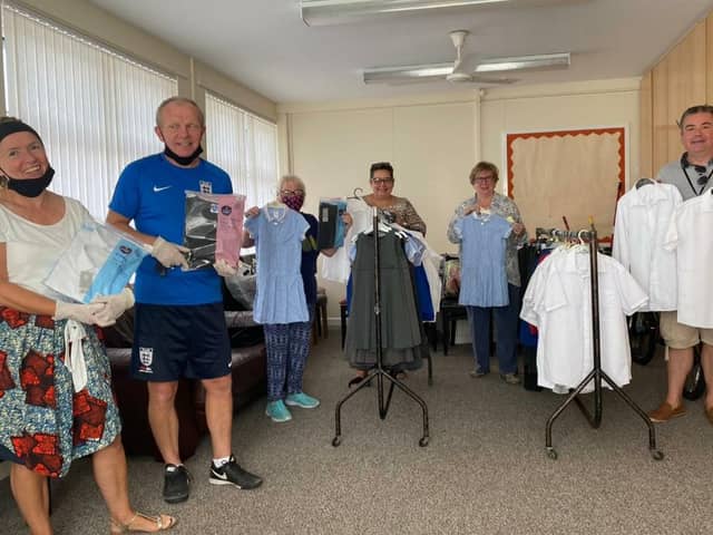Bev and volunteers with some of the donated school uniforms