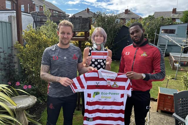 James Coppinger and Reo Griffiths present Doncaster mum-of-one Kate Mallinson with a signed shirt to raffle off to help raise funds for her life-saving surgery.