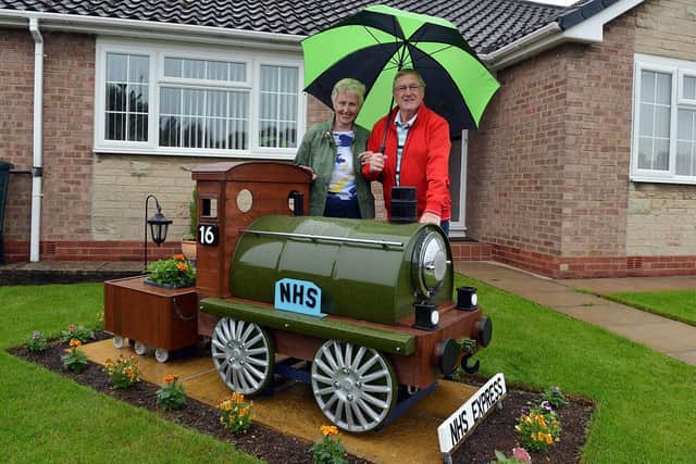 Michael Julian made a train in his front garden during lockdown. Michael and wife Ann Julian with the train.