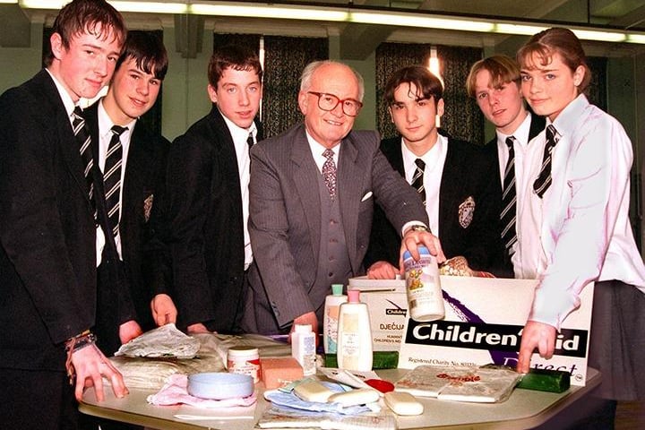 Peter Ford, Appeals Manager with Children's Aid Direct, shows some of Armthorpe Comprehensive School's fund-raising youngsters exactly what a baby box for Bosnia contains. The pupils pictured are, from left, Michael Love, Mark Hughes, Ryan Brewster, Anthony Nelson, Peter Liversidge and Catharine Marsh, February 1997