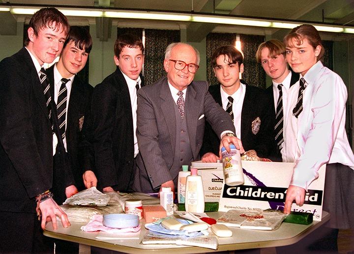 Peter Ford, Appeals Manager with Children's Aid Direct, shows some of Armthorpe Comprehensive School's fund-raising youngsters exactly what a baby box for Bosnia contains. The pupils pictured are, from left, Michael Love, Mark Hughes, Ryan Brewster, Anthony Nelson, Peter Liversidge and Catharine Marsh, February 1997
