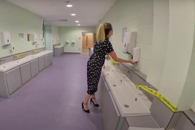 Outwood Academy Adwick assistant principal Hannah Smith shows the toilets area where some hand  basins have been closed off to help social distancing