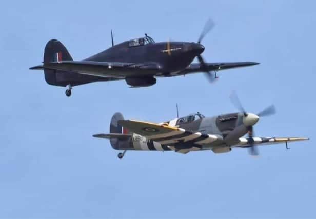 A Spitfire and a Hurricane in flight.