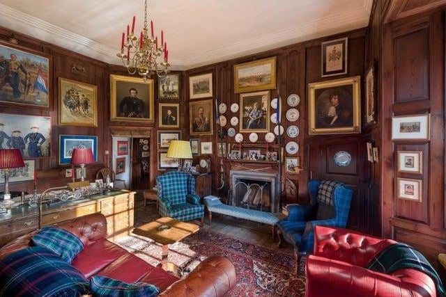 One of the eight reception rooms, this library room has a log fire.